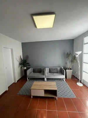 a living room with a couch and a table at ALOJAMIENTO CON JARDIN 20KM BARCELONA in Vilassar de Dalt