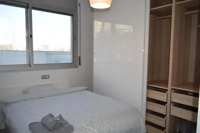 a small bedroom with a bed and a window at Magnificent apartment close to the beach in Barcelona