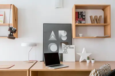 a desk with a laptop and a book on it at Residencia Universitaria Resa Francesc Giralt i Serrà in Terrassa