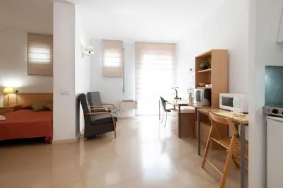 a living room with a bed and a dining room at Residencia Universitaria Resa Francesc Giralt i Serrà in Terrassa