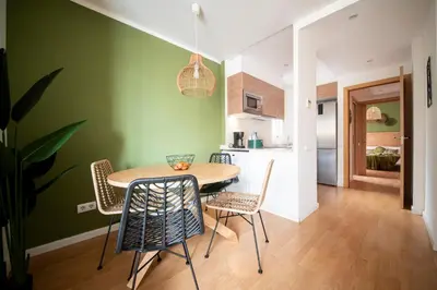 a kitchen and dining room with a table and chairs at You Stylish Sagrada Familia Apartments in Barcelona