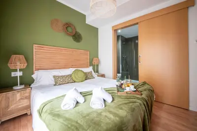 a bedroom with a bed with white towels on it at You Stylish Sagrada Familia Apartments in Barcelona