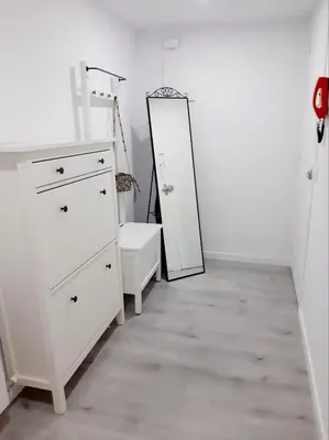 a bedroom with a white dresser and a mirror at Nur Apartment in Terrassa