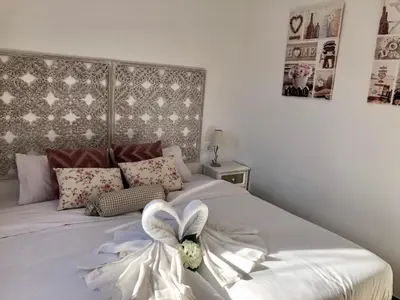 a bedroom with a bed with a white bow on it at Vilamarlux IV in Vilassar de Mar