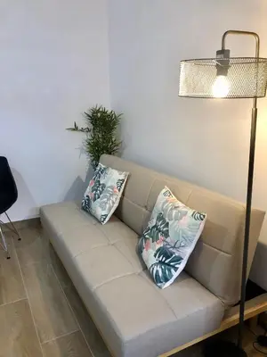 a couch with two pillows on it in a room at Vilamarlux IV in Vilassar de Mar