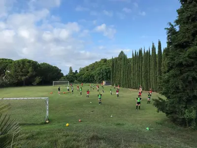 a group of girls playing soccer on a field at Casa Vila Reyes in Sant Vicenç de Montalt