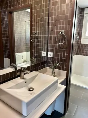 a bathroom with a sink and a mirror and a tub at Casa Vila Reyes in Sant Vicenç de Montalt
