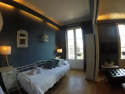 a bedroom with a large bed with blue walls at Mr. Serrano Apartments in Barcelona