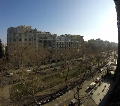 a city with a large building and a street with cars at Mr. Serrano Apartments in Barcelona