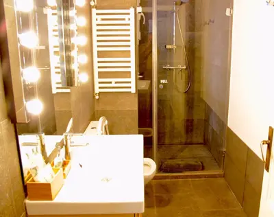 a bathroom with a shower and a sink and a toilet at Mr. Serrano Apartments in Barcelona