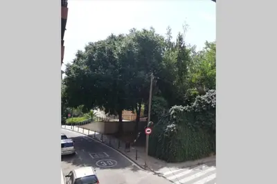 an aerial view of a street with trees and a fence at Chopin Magic Fountain in Barcelona