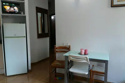 a kitchen with a blue table and a refrigerator at Chopin Magic Fountain in Barcelona