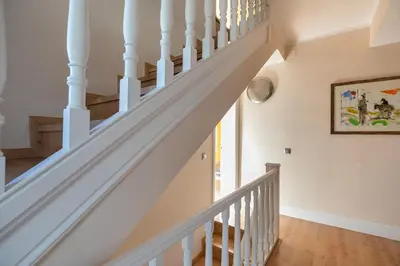 a staircase in a home with white railings at TOWANDA HOUSE in Sant Just Desvern