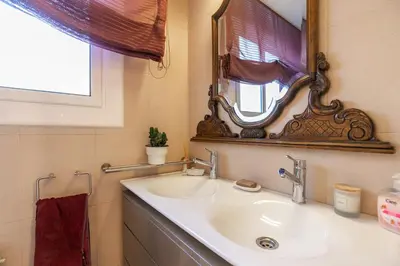 a bathroom with a sink and a mirror at TOWANDA HOUSE in Sant Just Desvern