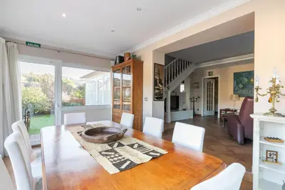 a dining room with a table and white chairs at TOWANDA HOUSE in Sant Just Desvern