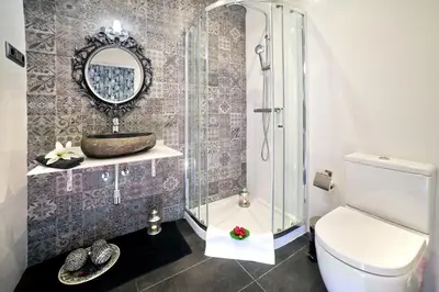a bathroom with a shower and a toilet and a sink at Villa Victoria Barcelona in Barcelona