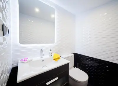 a bathroom with a white sink and a toilet at Villa Victoria Barcelona in Barcelona