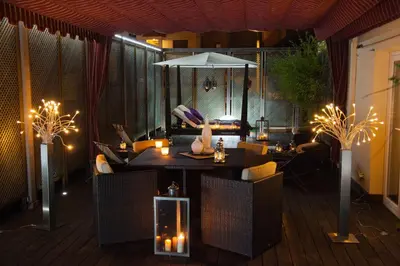 a patio with a table and chairs and an umbrella at Villa Victoria Barcelona in Barcelona