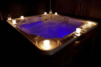 a bath tub with lights and a blue bathtub with candles at Villa Victoria Barcelona in Barcelona