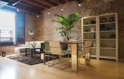 a dining room with a table and chairs and a couch at Lux Apartments Barcelona in Barcelona