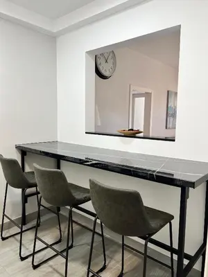 a table with chairs in a room with a mirror at Family-Friendly Home in Central Barcelona 4BDR in Barcelona