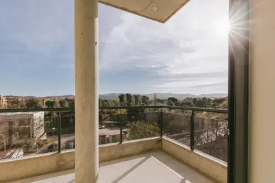 a balcony with a view of the city at CIM Aparthotel in Sant Cugat del Vallès