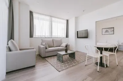 a living room with a couch and a table at CIM Aparthotel in Sant Cugat del Vallès