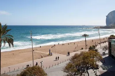 a group of people walking on a beach at Easystaybcn2 in Barcelona
