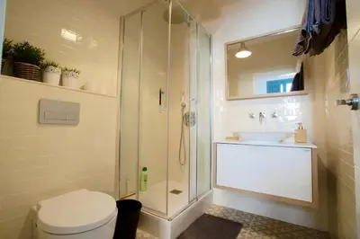 a bathroom with a shower and a toilet and a sink at LOVELY FLAT FIRA MWC in Hospitalet de Llobregat