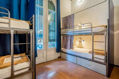 a hostel room with bunk beds and a window at Casa Barcelo Hostel Barcelona in Barcelona