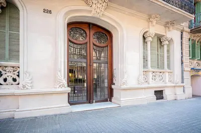 a building with a large wooden door on a street at Casa Barcelo Hostel Barcelona in Barcelona