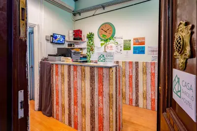 a room with a counter and a clock on the wall at Casa Barcelo Hostel Barcelona in Barcelona