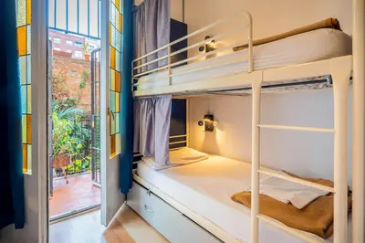 a room with bunk beds and a window at Casa Barcelo Hostel Barcelona in Barcelona