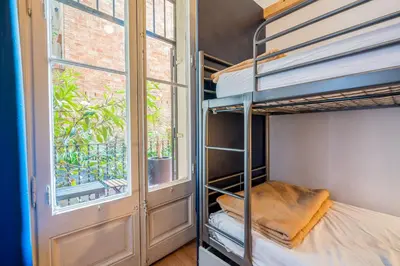 a bedroom with bunk beds and a window at Casa Barcelo Hostel Barcelona in Barcelona