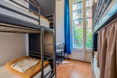 a dorm room with bunk beds and a window at Casa Barcelo Hostel Barcelona in Barcelona