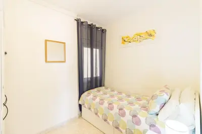 a bedroom with a bed and a window at Apartment in front of the Beach in Pineda de Mar