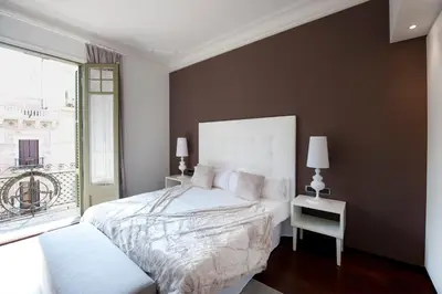 a bedroom with a white bed and a window at You Stylish El Born Apartments in Barcelona