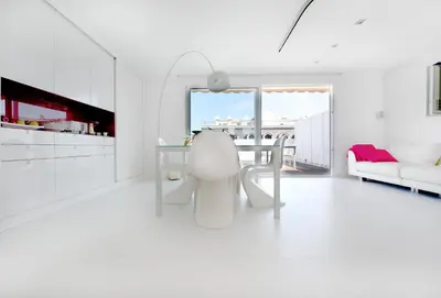 a white living room with a table and a couch at You Stylish El Born Apartments in Barcelona