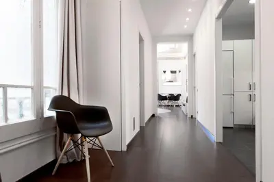 a black chair sitting in a room with a hallway at You Stylish El Born Apartments in Barcelona