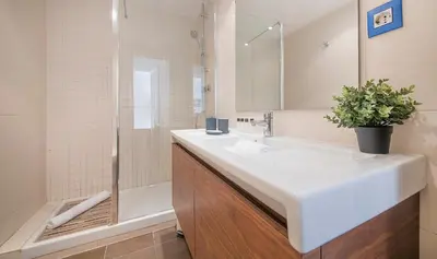 a white bathroom with a sink and a shower at You Stylish El Born Apartments in Barcelona