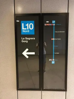 a person standing behind a door with a sign on it at Amazing Badalona Apartment With Terrace in Badalona