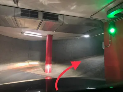 a red pole in a parking lot with a green light at Amazing Badalona Apartment With Terrace in Badalona