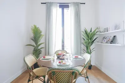 a white table with chairs and a plate of food at Sweett - Sepulveda in Barcelona