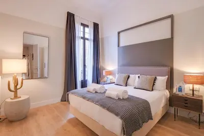 a bedroom with a large bed with two towels on it at Sweett - Sepulveda in Barcelona