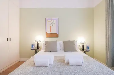 a bedroom with a large white bed with two tables at Sweett - Sepulveda in Barcelona