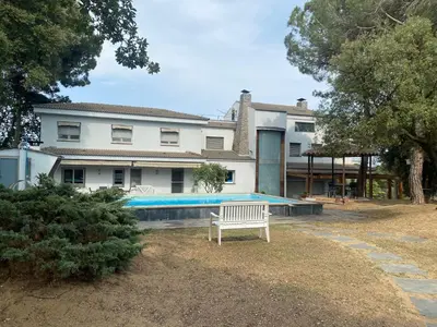 a house with a swimming pool in front of it at Can Ramón in Caldes de Montbui