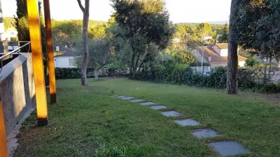a garden with a stone path in the grass at Can Ramón in Caldes de Montbui