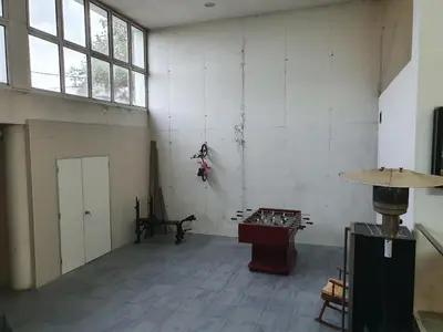 an empty room with a large window and a table at Can Ramón in Caldes de Montbui