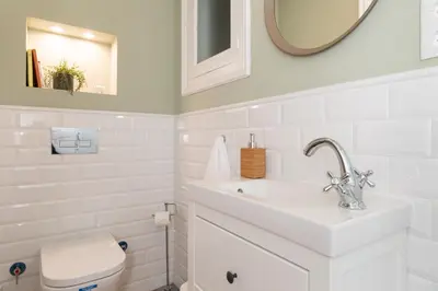 a white bathroom with a sink and a toilet at Casa Cosi - Putxet 4 in Barcelona