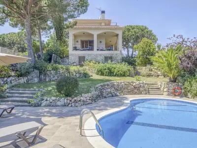 a villa with a swimming pool and a house at Villa in Arenys de Mar with Sea View in Arenys de Mar